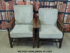 A pair of early 20thC oak armchairs or steamer chairs with adjustable backs