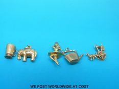 Five hallmarked 9ct gold charms, to include an elephant, kettle, tankard,
