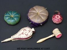 Five 19thC pin cushions including a carved bone gavel and bellows together with three lobed leather
