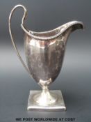 A Georgian hallmarked helmet shaped cream jug.