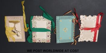 Four rare Georgian embroidered and gilt highlighted cut paper and card needle cases,