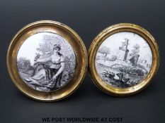 Two 18thC Bilston enamel cloak pins or chimney piece knobs, both decorated en grisaille,