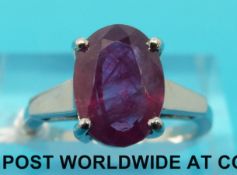 A white gold ring set with a large oval ruby (size K)