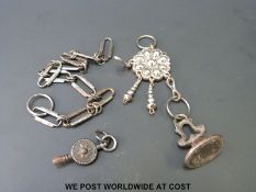 An 18thC cut steel armorial fob attached to a steel chatelaine,
