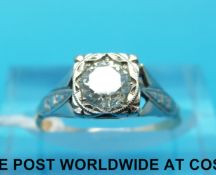 An 18ct gold ring set with a round brilliant cut diamond in an Art Deco style platinum setting