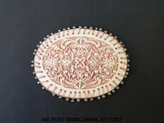 A 19thC finely carved bone pin cushion of exceptional quality, both sides decorated with ferns,