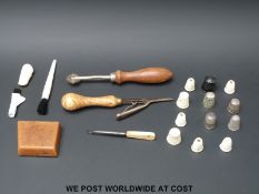 Three hallmarked silver thimbles, also bone and bakelite examples, a rug latchhook, leather marker,