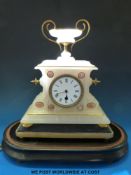 An alabaster clock on stand under a glass dome,