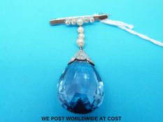 An 18ct white gold brooch set with seed pearls and diamonds with a large drop blue paste stone