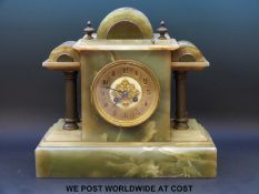 A 19th century onyx mantel clock, with brass columned decoration,