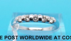 A 9ct white gold ring set with five diamonds (size P)
