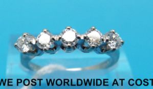 A white metal ring marked 14ct set with five round brilliant cut diamonds (size N)