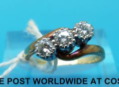 An 18ct gold ring set with three diamonds in a twist setting (size I)