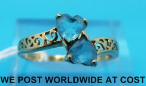 A 9ct gold ring set with two blue heart shaped topaz (size Q)