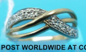 A 9ct gold ring set with diamonds in a cross over design (size Q/R)