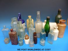 A collection of glass and stoneware bottles including Kidderminster,