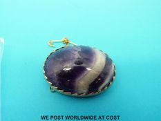 A yellow metal brooch set with blue john.