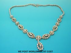 An 18ct white gold necklace set with round brilliant cut and baguette cut diamonds in circular and