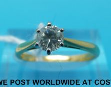 An 18ct gold ring set with a round brilliant cut diamond of approximately 0.