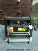 A Swood thickness/ planer woodworking machine.