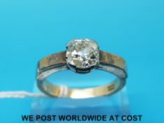 An 18ct gold ring set with a cushion cut diamond of approximately 1.