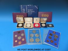 A quantity of cased collectable coins to include three silver commemorative crowns,
