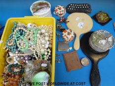 A box of costume jewellery to include beads, compacts,