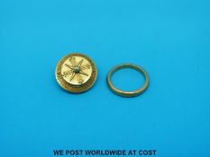 A 22ct gold wedding band (4.2g) and a Victorian yellow metal brooch (3.