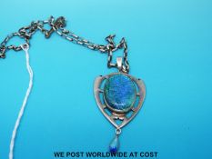 A hallmarked silver pendant in the Liberty style decorated with a blue cabochon