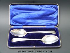 A cased pair of Hester Bateman Georgian bottom hallmarked feather edged table spoons,