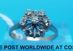 A 9ct gold ring set with cubic zirconia in a flower cluster (size K)