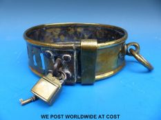A heavy Georgian/Victorian brass dog collar with four slot and loop adjustment with brass loop