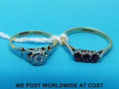An 18ct gold ring set with a diamond in a platinum setting and an 18ct gold ring set with three