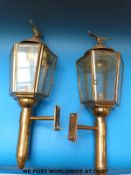 A pair of ornamental brass outdoor lights in the form of coaching lamps with eagle finials (53cm