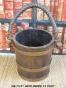 A coopered oak bucket with leather covered rope handle (H31 x diameter 30cms)