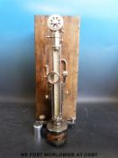 A vintage scleroscope in wooden case (for testing hardness of metal)