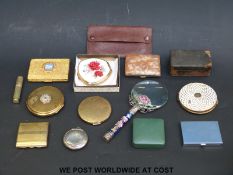 A collection of compacts including a hallmarked silver example, Kigu, Stratton,