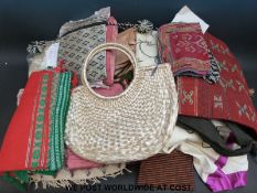 A collection of Middle Eastern style textiles to include scarves, two leather bags,