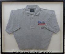 A Lewis Hamilton signed polo shirt in frame