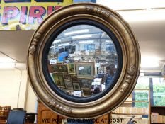 A circular gilt framed mirror with convex glass (overall size 59cm)