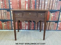 A mahogany lowboy with three drawers and shaped apron (H71 x W74 x D50cm)