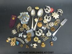 A selection of metal military lapel badges, an A.