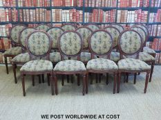 A set of fifteen upholstered dining chairs raised on tapering reeded legs