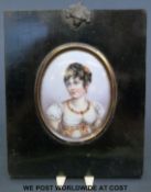 A portrait miniature on porcelain of a bejewelled lady in ebonised frame (overall height 15cm)