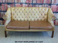 A pair of leather Chesterfield sofas with button backs and metal stud decoration,
