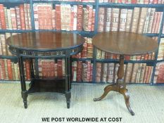 A Georgian tilt top table and an ebonised occasional table with columned supports and pierced