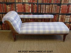 A 19thC carved mahogany chaise longue raised on turned legs and brass castors