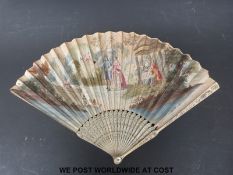 An ivory fan with inlaid metal pin decoration and hand coloured garden scene