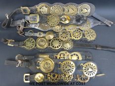 Eight martingales mounted with horse brasses including queens and kings crowns, heart motifs,