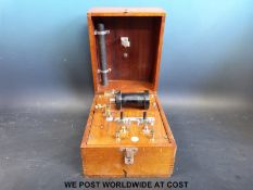 A Schall and Son of London 'Shock' machine in hinged wooden case bearing ivorine plaque